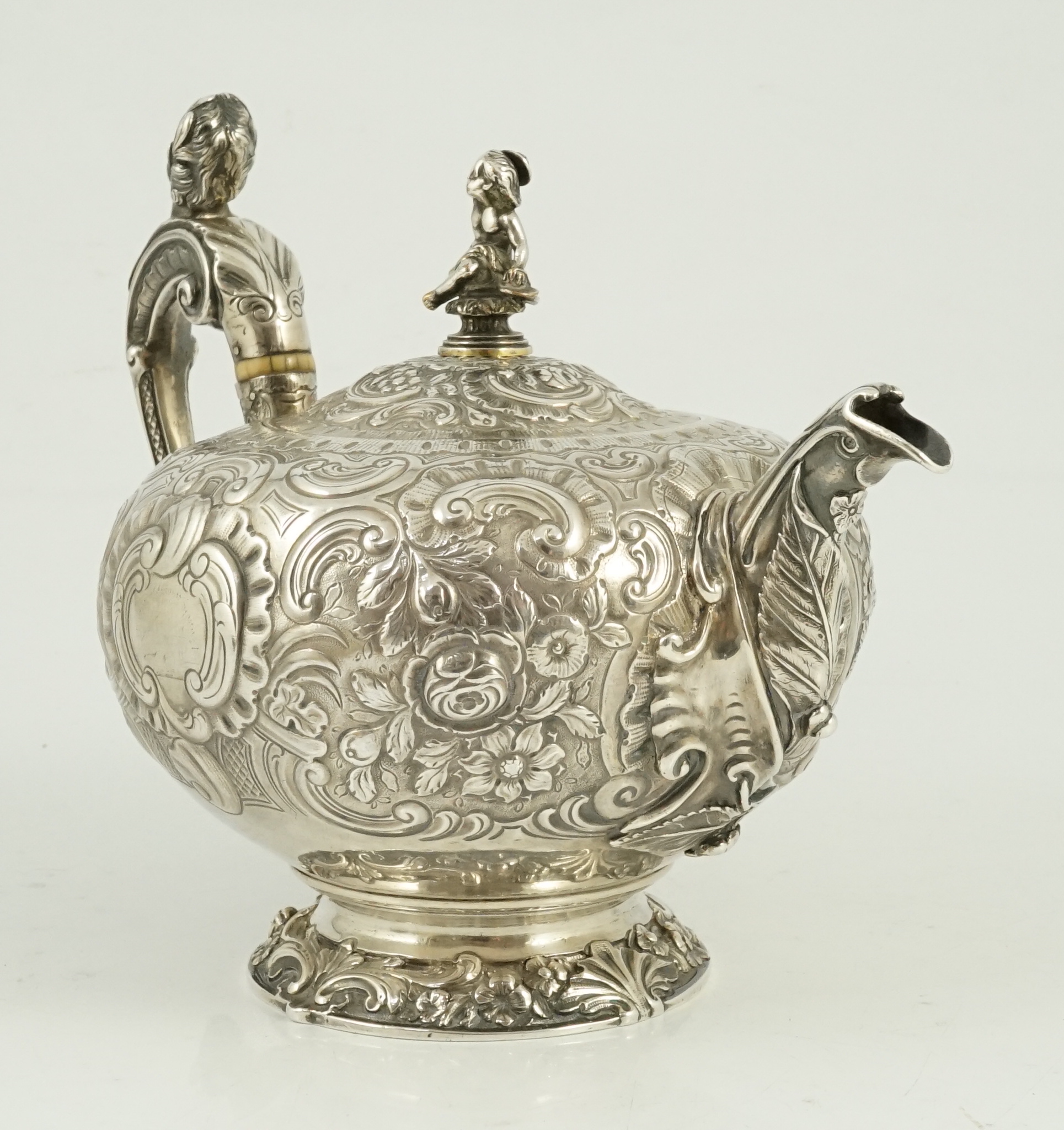 A George III silver rococo style inverted pear shaped pedestal teapot by Robert Garrard I